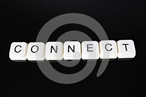 Connect text word title caption label cover backdrop background. Alphabet letter toy blocks on black reflective background. White