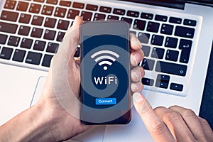 Connect to WiFi wireless internet network with smartphone at coffee shop or hotel with button on mobile device screen, free public