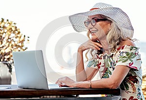 Connected and chilled. an attractive senior woman using a laptop while sitting outside at home.