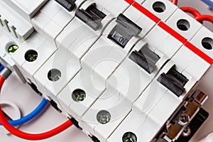 Connected by wires automatic circuit breakers in mounting box closeup