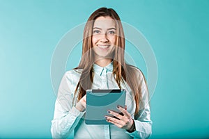 She always connected. Woman using digital tablet computer happy isolated on turquoise background. Portrait young caucasian woman