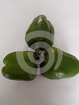 connectedness and love, green peppers  on white background