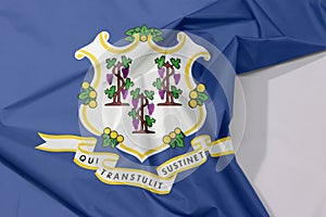 Connecticut fabric flag crepe and crease with white space. Three bunches of grapes on royal blue color. text below