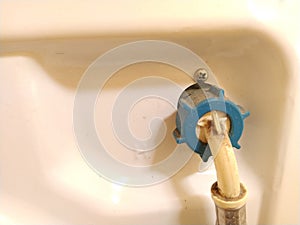 Connecting the hose of the washing machine or dishwasher to the water supply. A pipe is screwed to the body of household