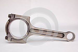 Connecting rod from a car engine  on white.