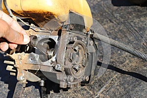 Connecting rod from a small petrol engine used on brush cutters. Repairing gasoline powered grass cutting machine