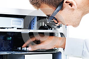 Connecting the wires. A hipster technician working on an electronical appliance.