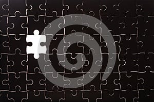 Pattern of black jigsaw puzzle and one of missing hole
