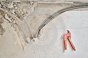 Connection heating pipes to white Radiator in a new apartment under construction. Work As A Plumber, mounting water