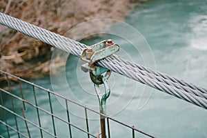 The connection of a large metal cable with a clip for the tether. The construction of a suspension metal bridge over the