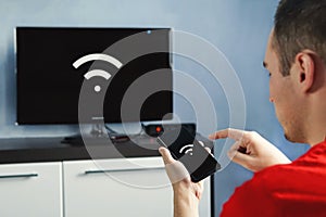 Connectivity between smart tv and smart phone through wifi connection photo