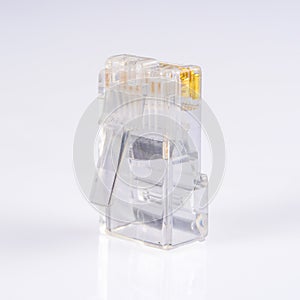 Connector rj-45. Transparent connector rj45 for network and internet. Close-up macro on light grey background with shadow