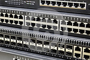 connectors of a large data center network switch. incoming and outgoing outputs