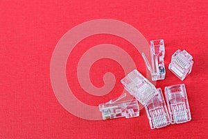 Connectors for networking ethernet cable with RJ45 on red background. Close-up