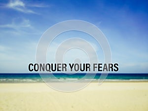 CONQUER YOUR FEARS text with nature background. Inspirational and motivational concept. Stock photo.