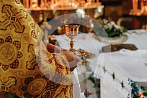 Consecrated bread and wine in chalice on Holy See, during orthodox liturgy on Easter