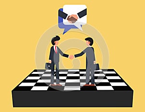 Consensus building and strategic partnership. Businessman firmly shaking hands standing on giant chess board