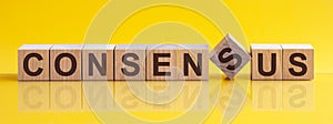 CONSENSUS word made with building blocks on the bright yellow background