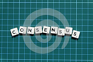 Consensus word made of square letter block on green square mat background