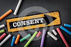 Consent. Direction arrow with text on a dark chalkboard background