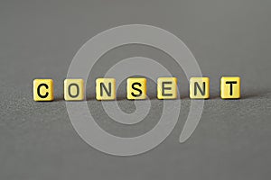 Consent - word concept on cubes