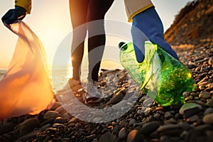 Conservation of ecology and Earth Day. A volunteer collects plastic bottles by the sea. Coastal cleanup for recycling