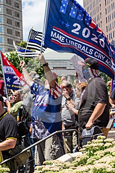 Conservative Demonstrator Holds Up a Trump 2020 Flag that Reads Make Liberals Cry Again