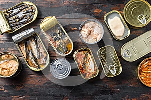 Conserves of canned fish with different types of seafood, opened and closed cans with Saury, mackerel, sprats, sardines, pilchard