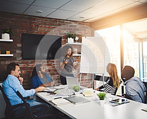 Considering all the factors in their business performance. a businesswoman giving a presentation to her colleagues in an