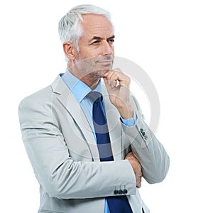 Considering all his options...Studio shot of a handsome businessman looking deep in thought isolated on white.