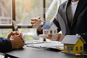 Considering buying a home, investing in real estate. Broker signs a sales agreement. agent, lease agreement, successful deal