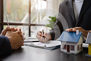 Considering buying a home, investing in real estate. Broker signs a sales agreement. agent, lease agreement, successful deal