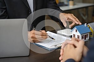 Considering buying a home, investing in real estate. Broker signs a sales agreement. agent, lease agreement, successful deal