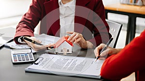 Considering buying a home, investing in real estate. Broker signs a sales agreement. agent, lease agreement, successful deal in