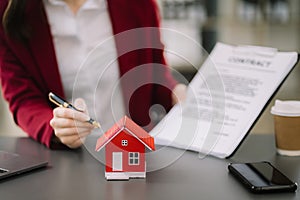 Considering buying a home, investing in real estate. Broker signs a sales agreement. agent, lease agreement, successful deal