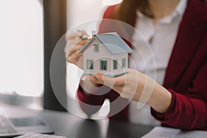 Considering buying a home, investing in real estate. Broker signs a sales agreement. agent, lease agreement, successful deal