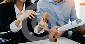 Considering buying a home, investing in real estate. Broker signs a sales agreement. agent, lease agreement, successful deal