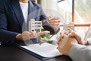 Considering buying a home, investing in real estate. Broker signs a sales agreement. agent, lease agreement, successful deal