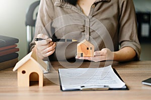 Considering buying a home, investing in real estate. Broker signs a sales agreement. agent, lease agreement, successful deal