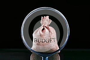 Considers the budget through a magnifying glass close up. Economic Speculation.