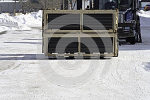 Consignment of crates delivered at customers warehouse using forklift photo