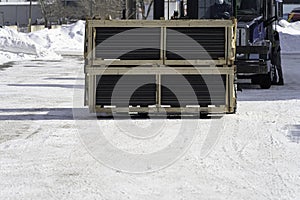 Consignment of crates delivered at customers warehouse using forklift