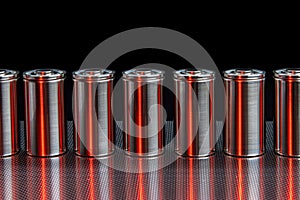 A consignment of new modern high-capacity lithium-ion cells. A prototype of new batteries on a steel surface illuminated with red photo