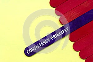 Consistency principle text on purple color wooden stick. Accounting concept.