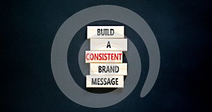 Consistent brand message symbol. Concept words build a consistent brand message on wooden blocks. Beautiful black table black