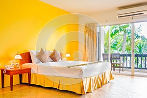 Interior decoration of romantic plain yellow bedroom with balcony