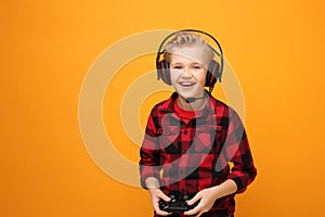 Console game. Young boy playing computer games on headphones.
