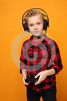 Console game. Young boy playing computer games on headphones.