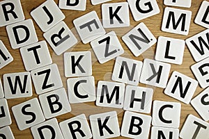 Consonants lying on school desk photo