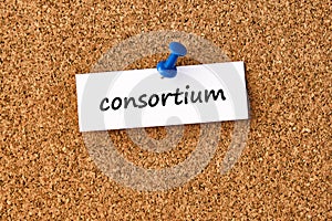 Consortium. Word written on a piece of paper, cork board background photo